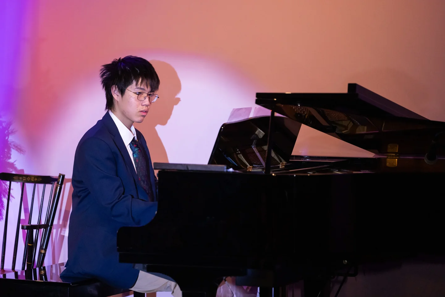 Lala performing on a grand piano